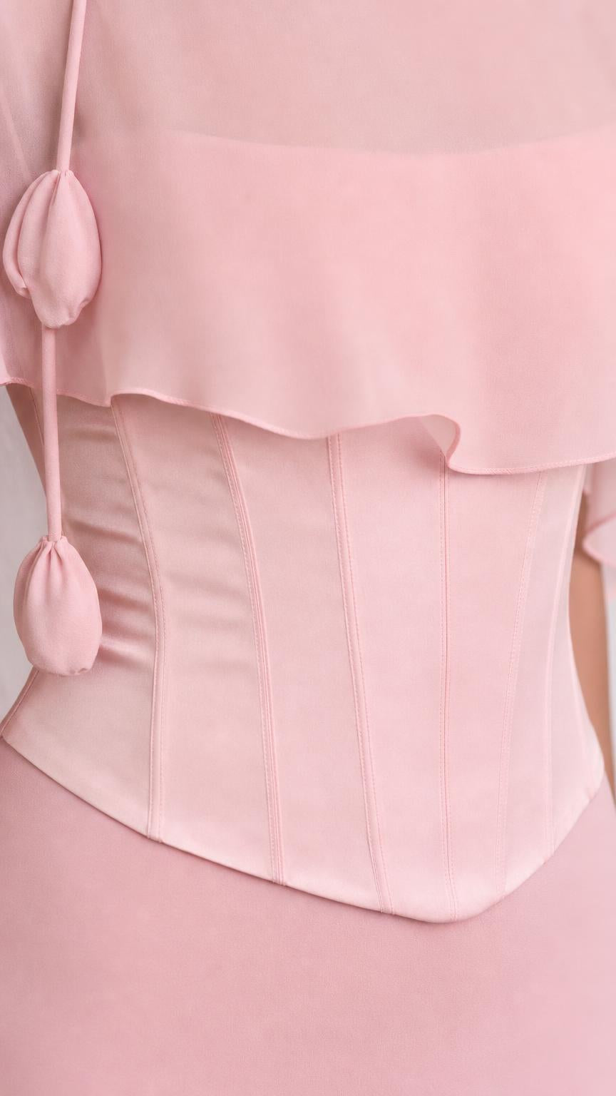 Close-up of pink dress bodice and tassel accents