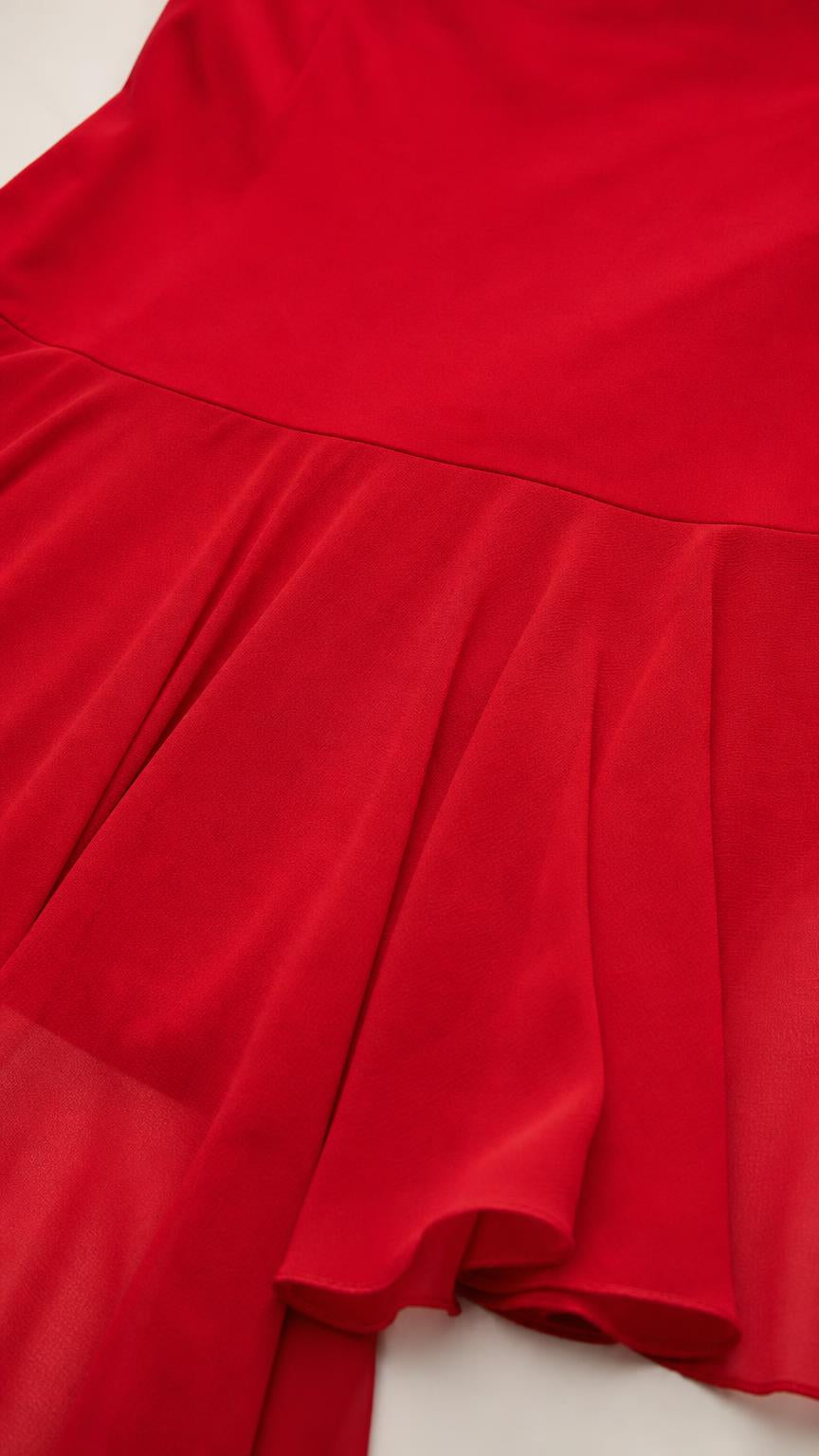 Close up of red fabric and pleated hem detail