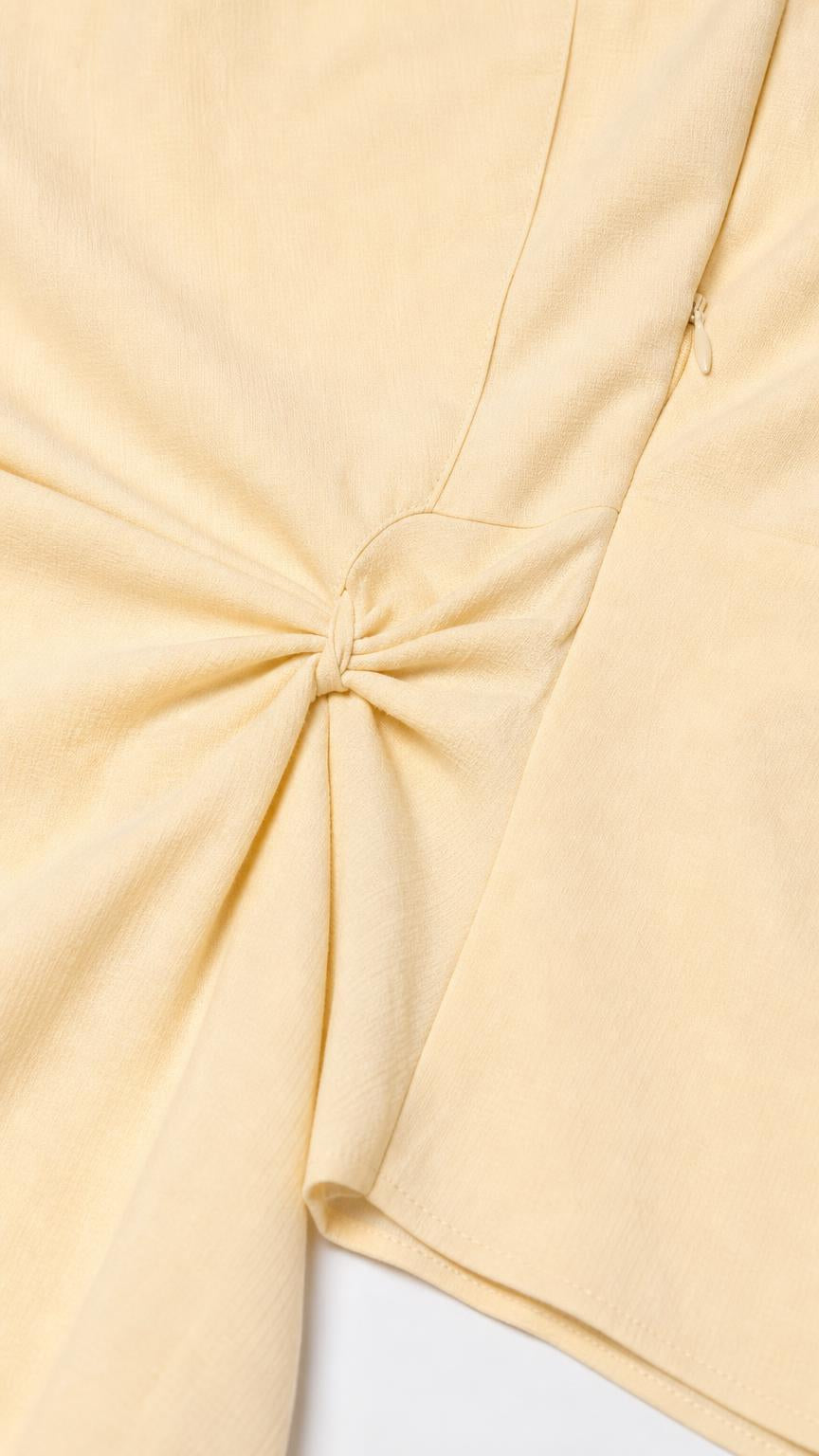 Close-up detail of side knot on yellow midi dress